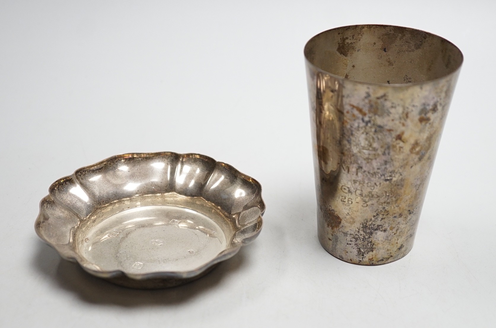 A late Victorian silver beaker, with later engraved inscription, London, 1898, 9.8cm and a 1970's silver small dish, 6.1oz.